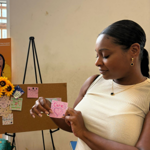 A photograph of our Ambassador Melica holding a card